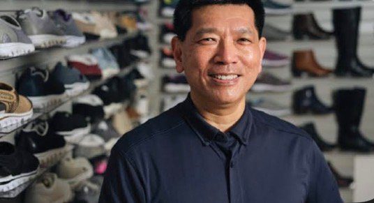 Person in front of shoe display