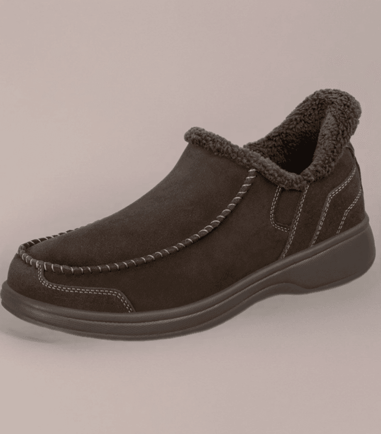 Brown suede slip-on boot with a plush shearling lining and prominent white stitching along the seams, on a dark sole.