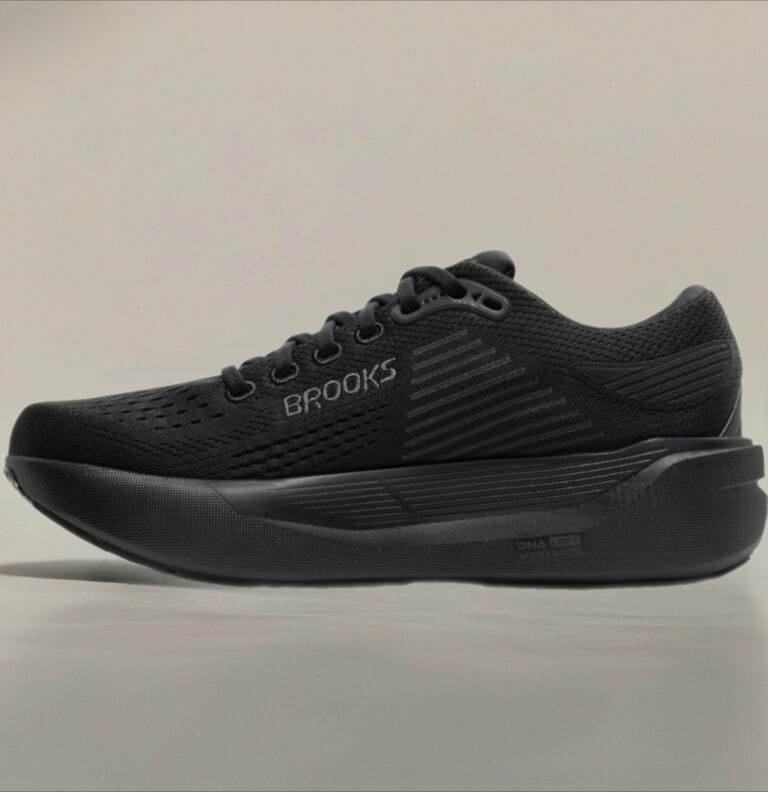 Black Brooks running shoe side view with breathable perforated upper and thick cushioned midsole.