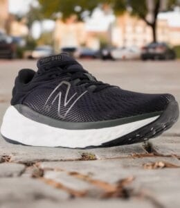 Bazaart_20260724_112010_313 - Rejuva Sole™ Black running shoe with a white midsole resting on a pavement; gray N-logo on the side and 'Fresh Foam 840' on the tongue.