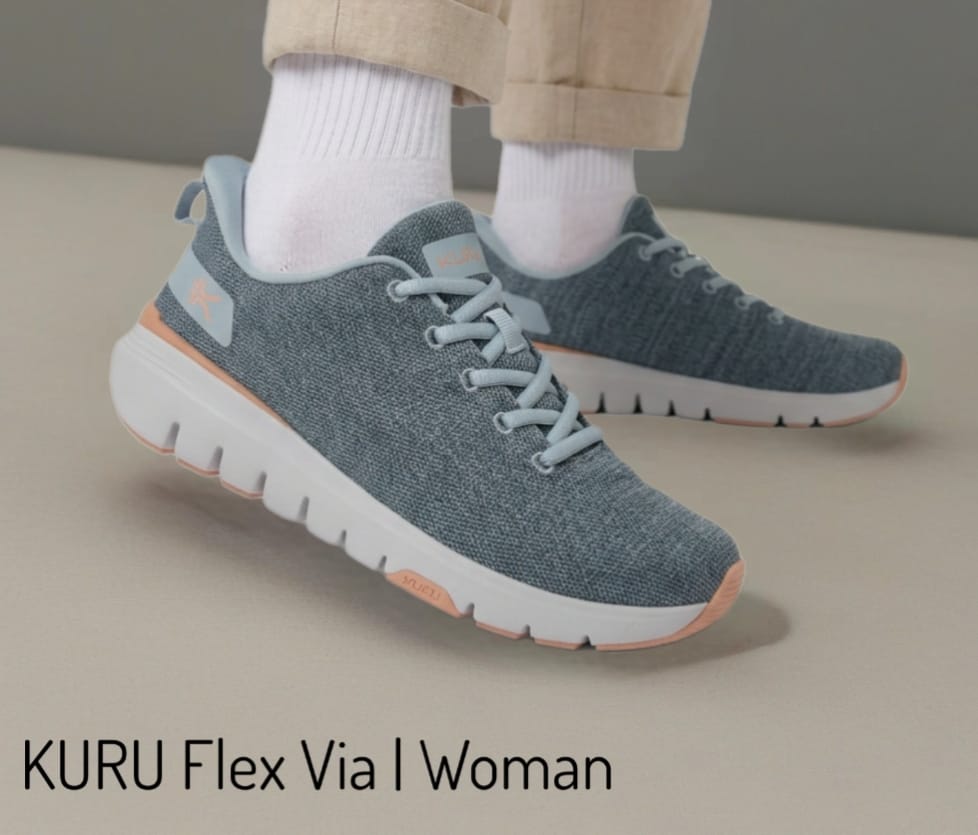 Blue knit athletic sneakers with white soles and peach accents worn with white socks; brand text 'KURU Flex Via Women' visible.
